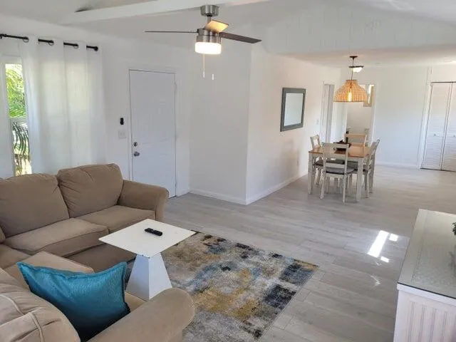 a living room with furniture and a wooden floor