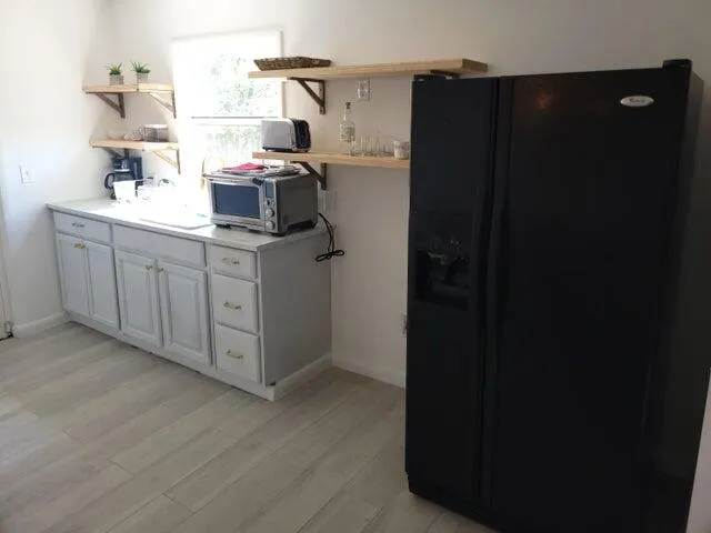 a kitchen with a refrigerator and cabinets