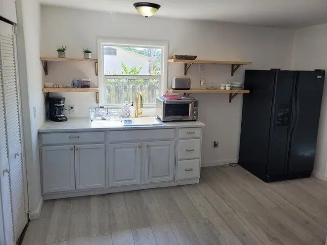a kitchen with a refrigerator and window