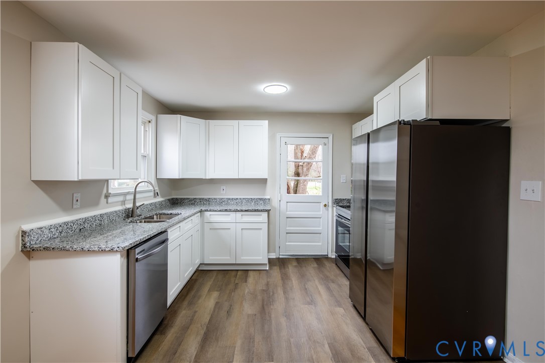 2600 Hungary Road Henrico, VA 23228 - Photo 11 of 43 a kitchen with a refrigerator and a sink