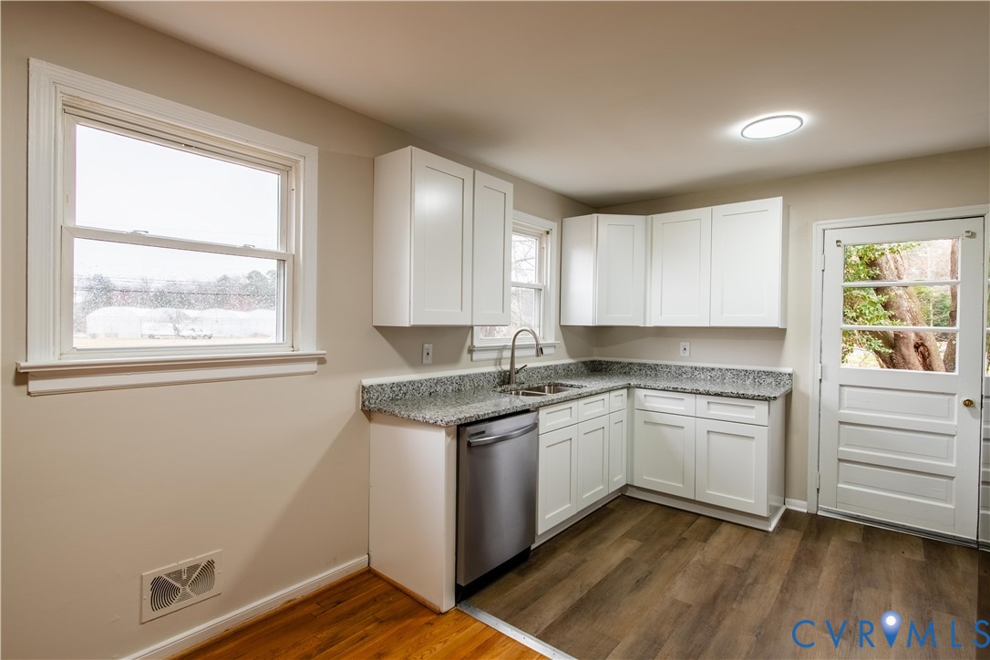 2600 Hungary Road Henrico, VA 23228 - Photo 12 of 43 a kitchen with a stove cabinets and wooden floor