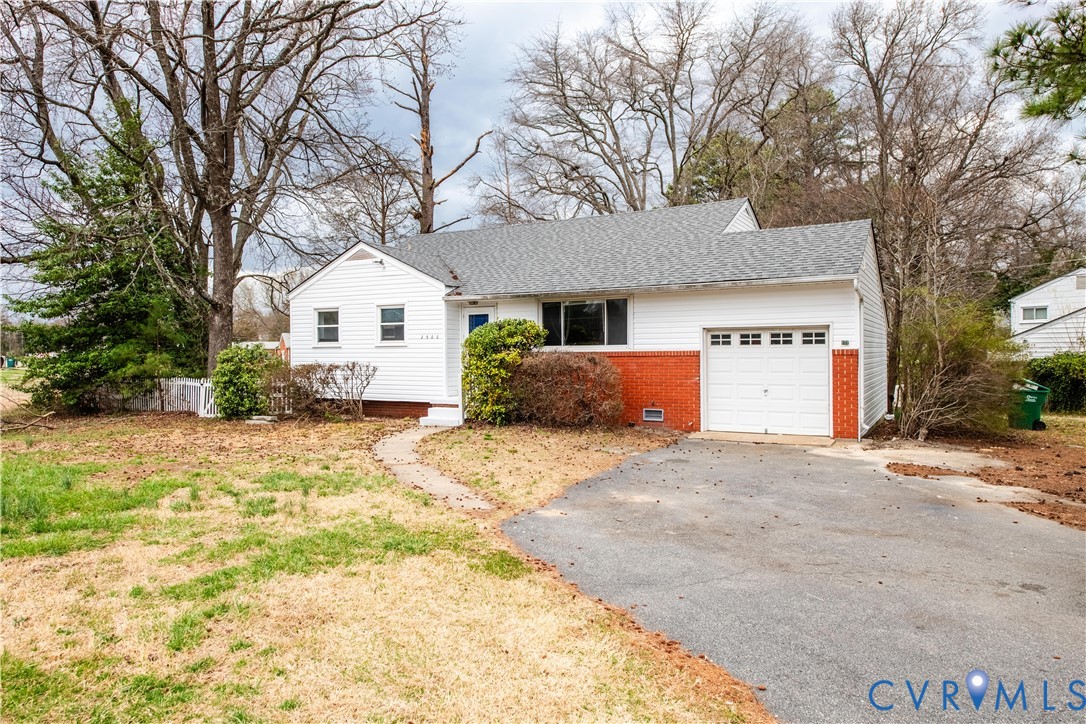 2600 Hungary Road Henrico, VA 23228 - Photo 4 of 43 a front view of a house with a yard and garage