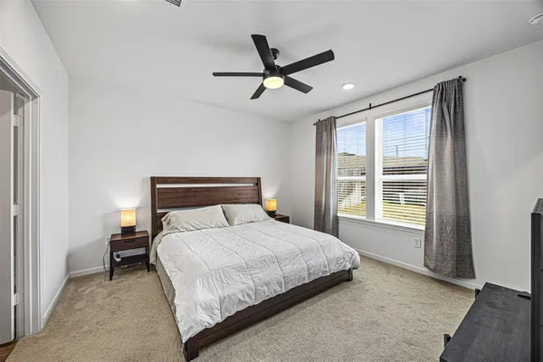 a bedroom with a bed and window