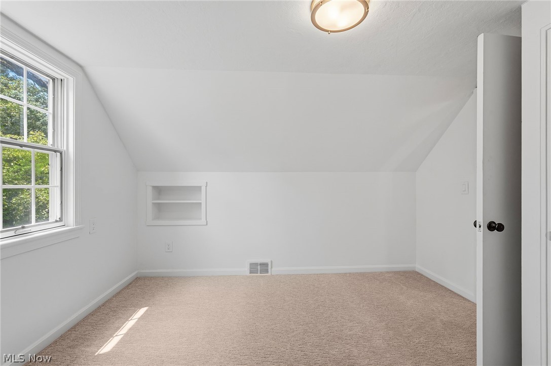 7750 Lewis Road Olmsted Falls, OH 44138 - Photo 29 of 50 Carpeted room featuring a white interior, built-in shelving, a double-hung window, and a flush mount ceiling light fixture