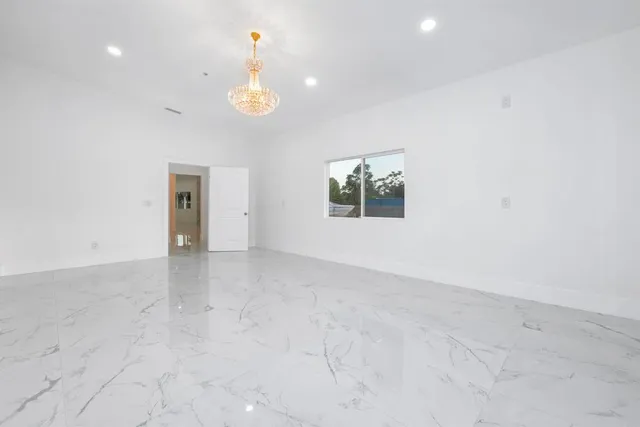 an empty room with windows and entrance