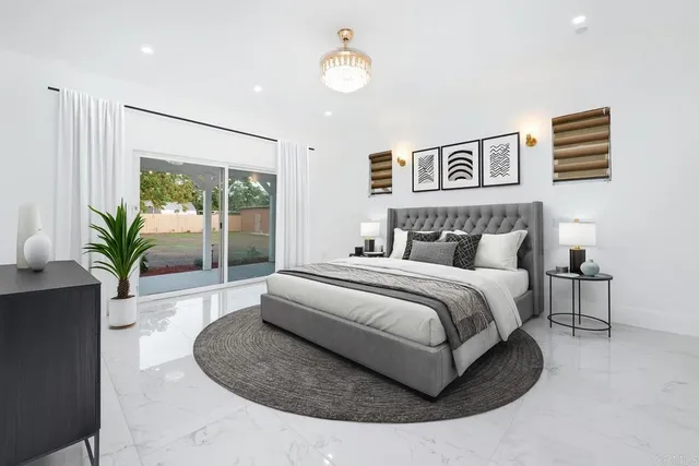 a bedroom with a large bed and a potted plant