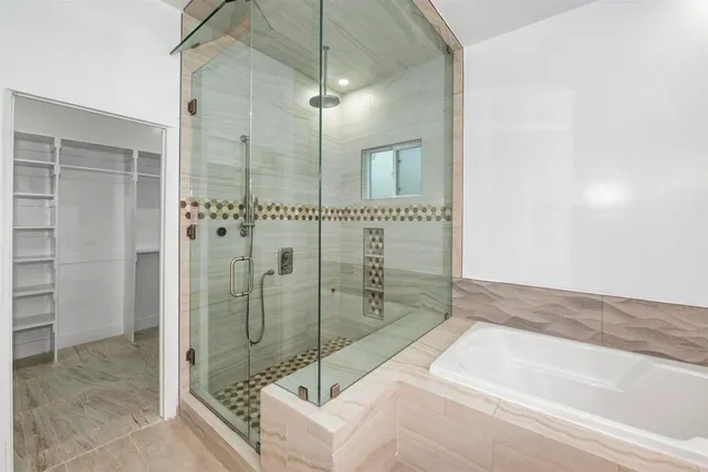 a bathroom with a bathtub and a shower