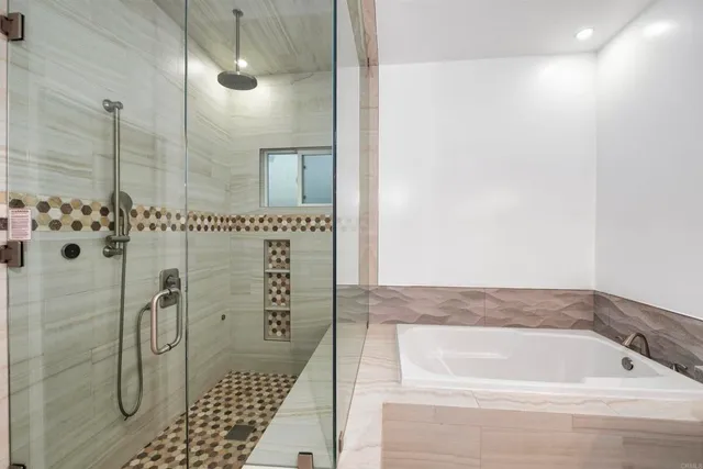 a bathroom with a bathtub and shower