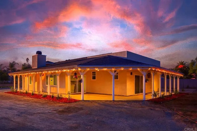 a blue building with swimming pool in front of it