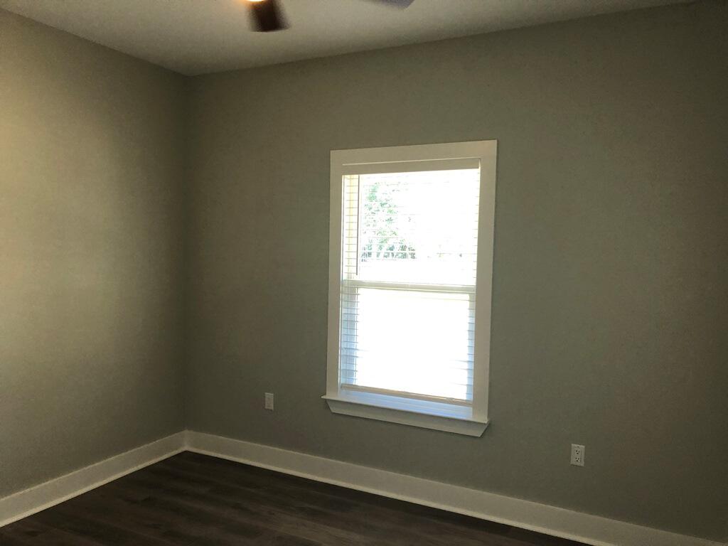 52 Magnolia Street Niceville, FL 32578 - Photo 11 of 16 a view of an empty room with wooden floor and a window