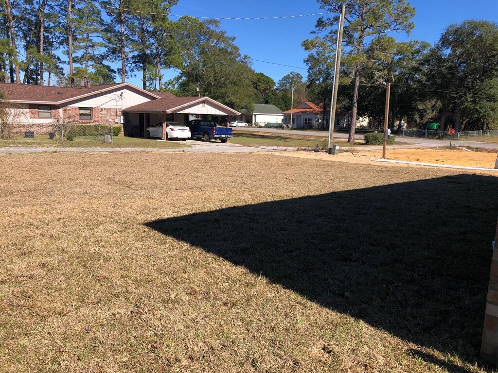 52 Magnolia Street Niceville, FL 32578 - Photo 15 of 16 a front view of a house with a yard and trees
