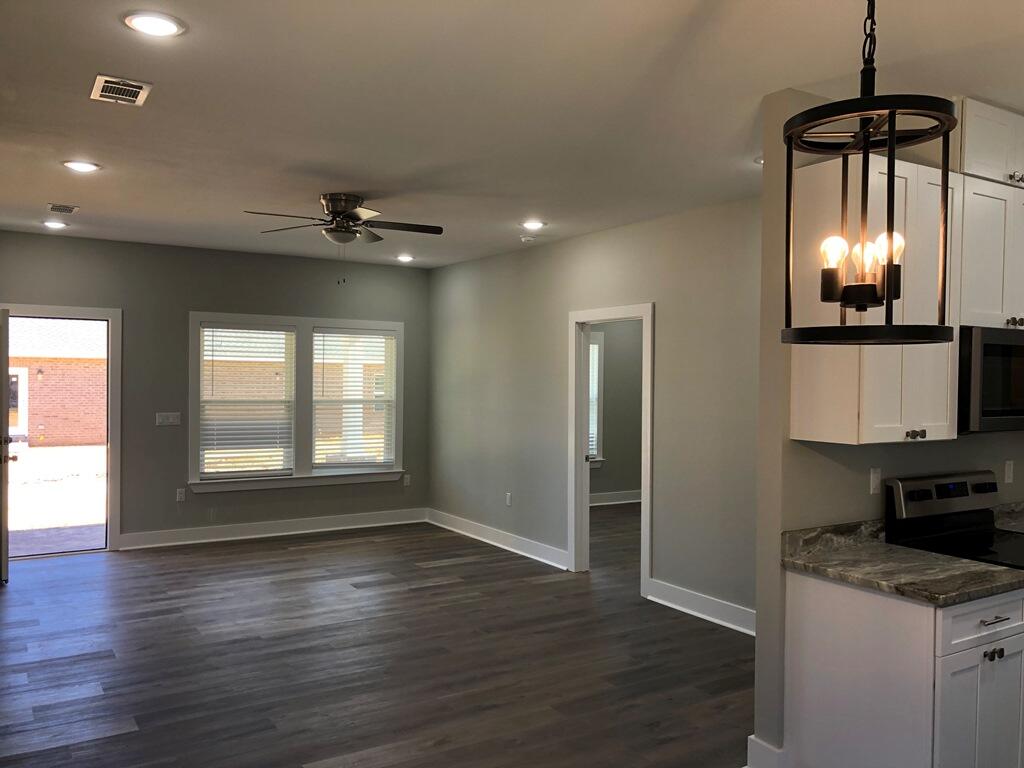 52 Magnolia Street Niceville, FL 32578 - Photo 5 of 16 wooden floor in an empty room with a window
