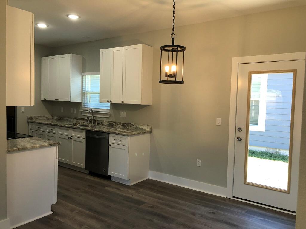 52 Magnolia Street Niceville, FL 32578 - Photo 6 of 16 a kitchen with a refrigerator stove and wooden floor
