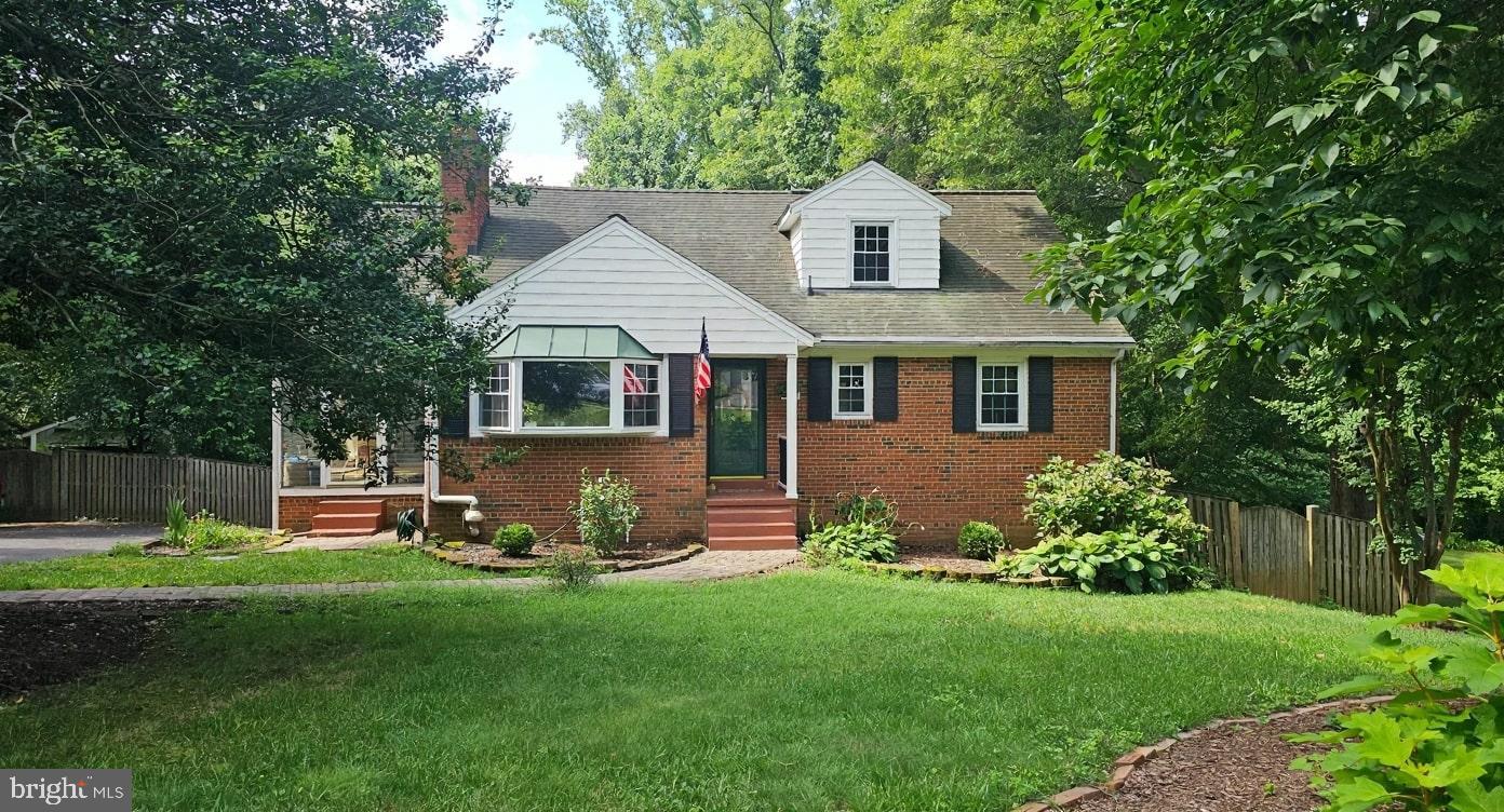 a front view of a house with a yard and green space