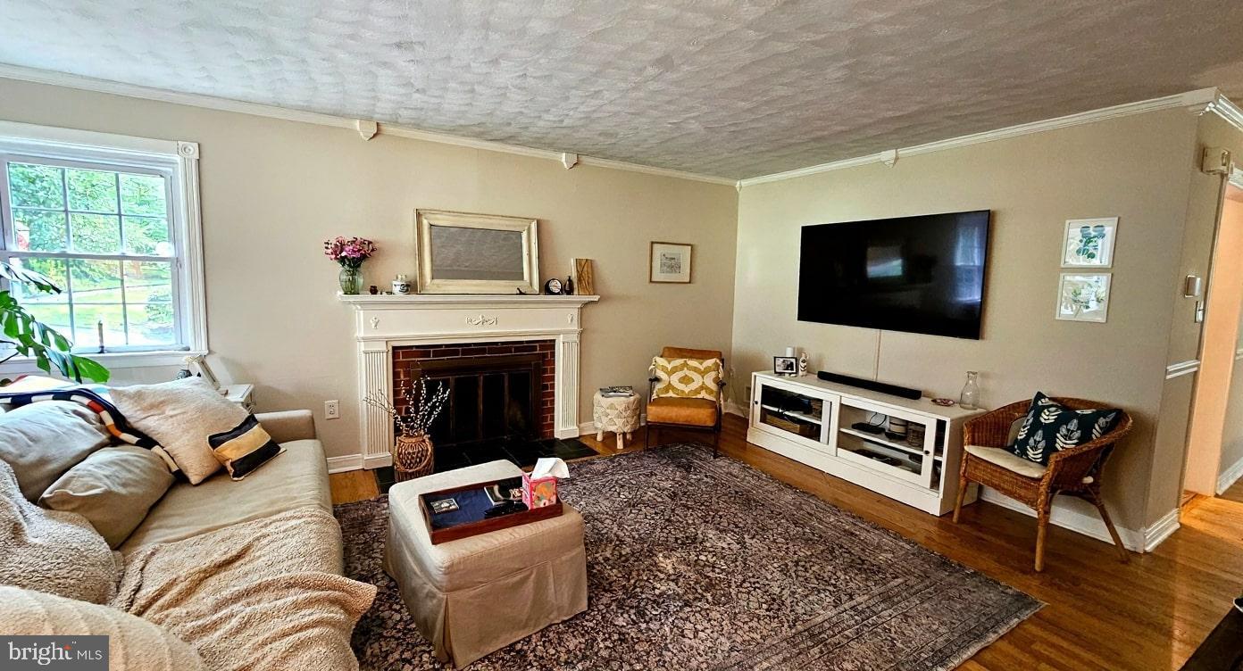 4021 Laurel Road Alexandria, VA 22309 - Photo 2 of 31 a living room with furniture a flat screen tv and a fireplace