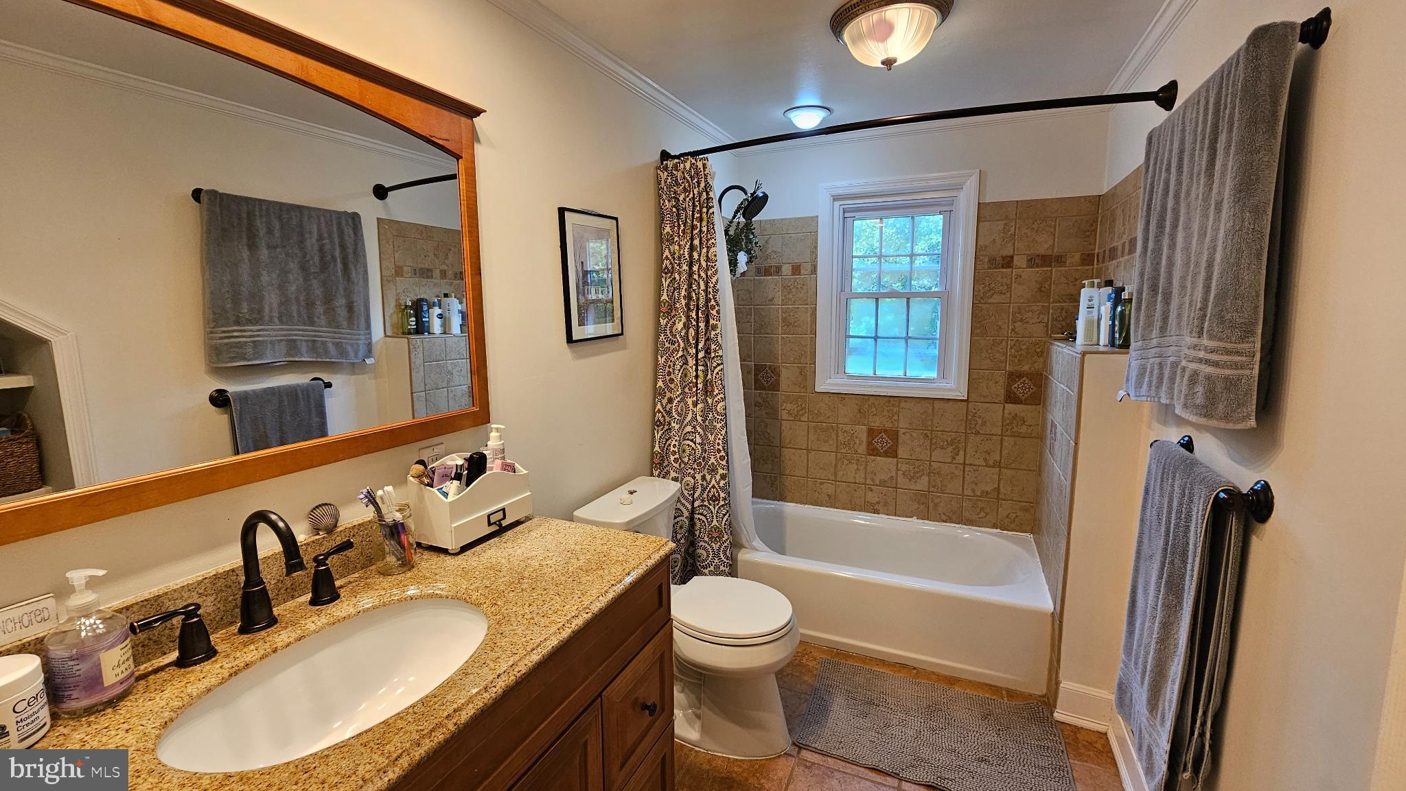 4021 Laurel Road Alexandria, VA 22309 - Photo 21 of 31 a bathroom with a granite countertop sink toilet a mirror and shower