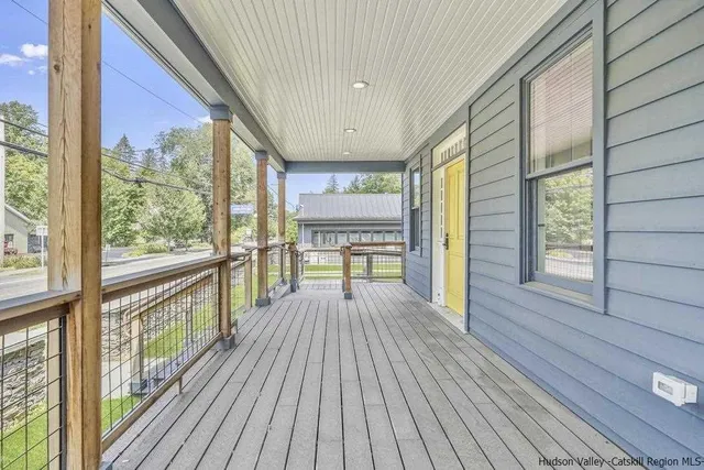 a view of big room with wooden floor and windows