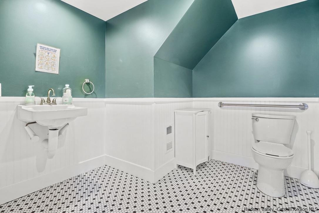 3603-3611 Main Street Stone Ridge, NY 12484 - Photo 14 of 28 a bathroom with a sink a toilet and a mirror