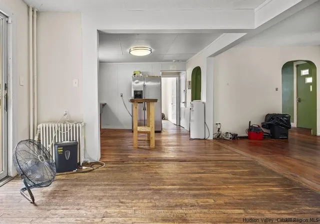 a view of a livingroom with wooden floor and furniture
