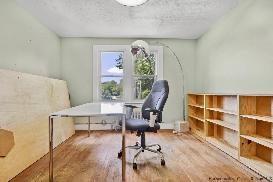 3603-3611 Main Street Stone Ridge, NY 12484 - Photo 23 of 28 a view of a livingroom with workspace and a window