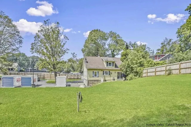 a house view with a sitting space and garden