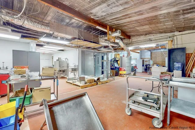 a living room with lots of furniture and kitchen view