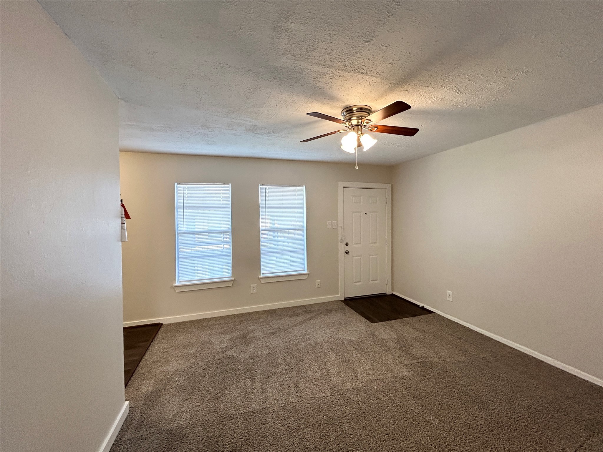 5415 Scott Street, Unit 12 Houston, TX 77021 - Photo 5 of 16 an empty room with chandelier fan and windows