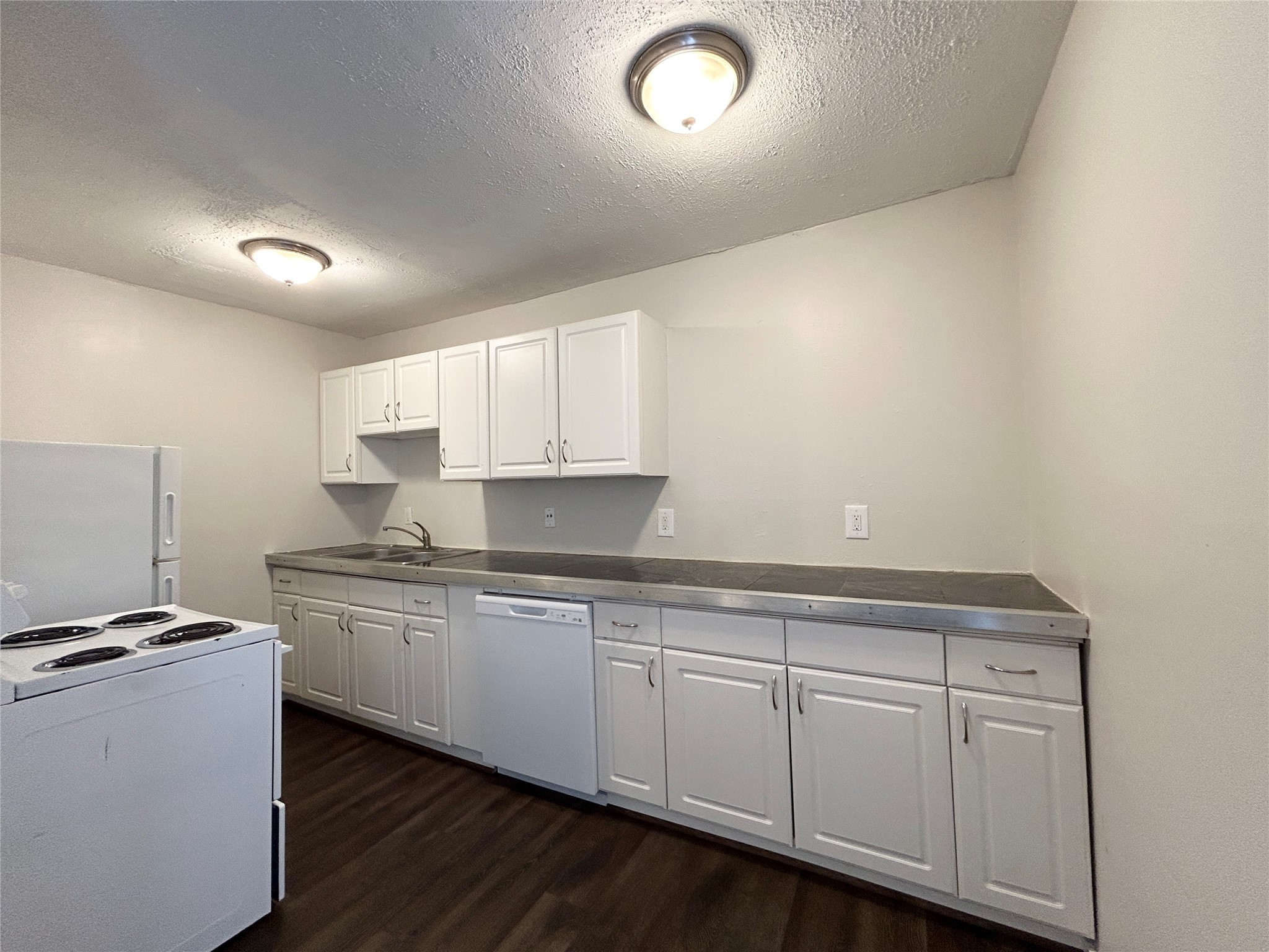 5415 Scott Street, Unit 12 Houston, TX 77021 - Photo 7 of 16 a kitchen with white cabinets and sink