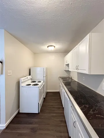 a kitchen with wooden cabinets and stainless steel appliances