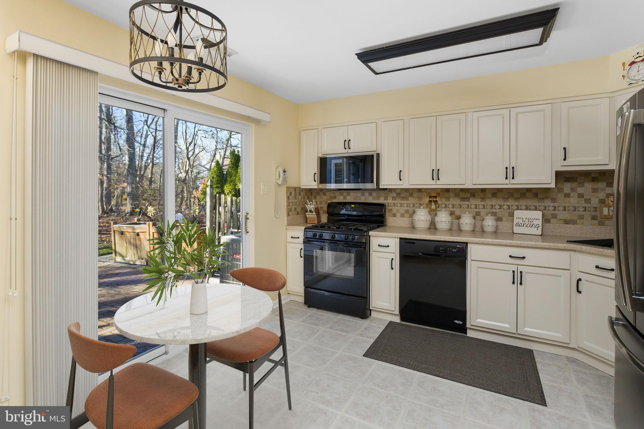 8 Kettlebrook Drive Mount Laurel, NJ 08054 - Photo 13 of 37 a kitchen with stainless steel appliances granite countertop a stove a refrigerator a sink a stove and white cabinets with wooden floor