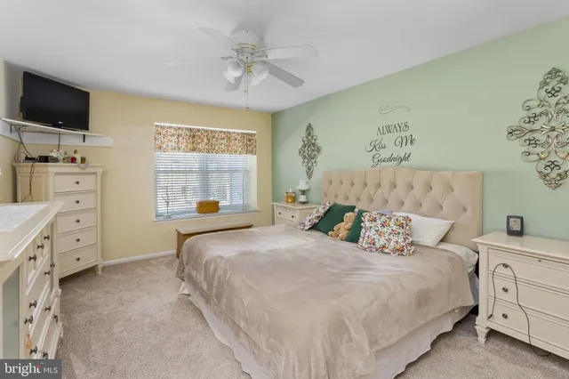 a bedroom with a baby bed and dresser