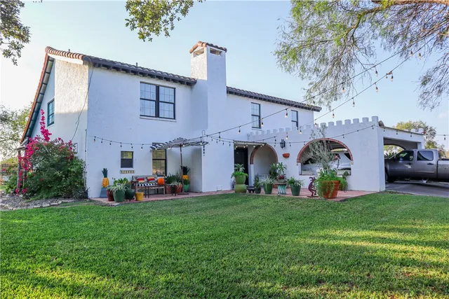 a front view of house with yard and car parked