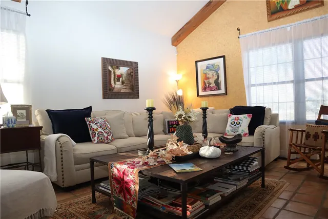 a living room with furniture and next to a window