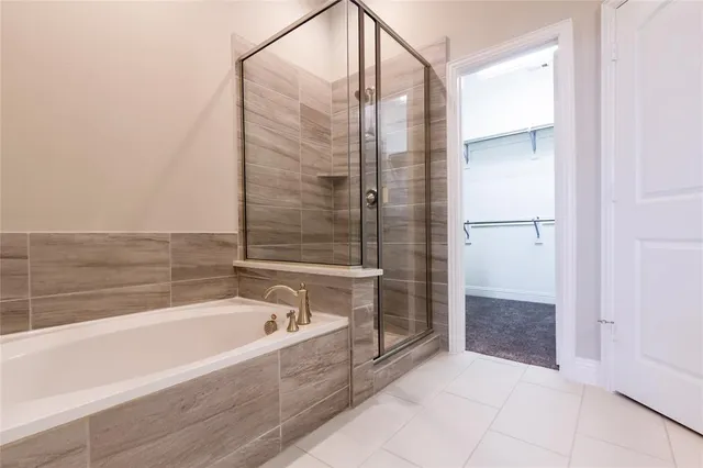 a spacious bathroom with a bathtub and a shower