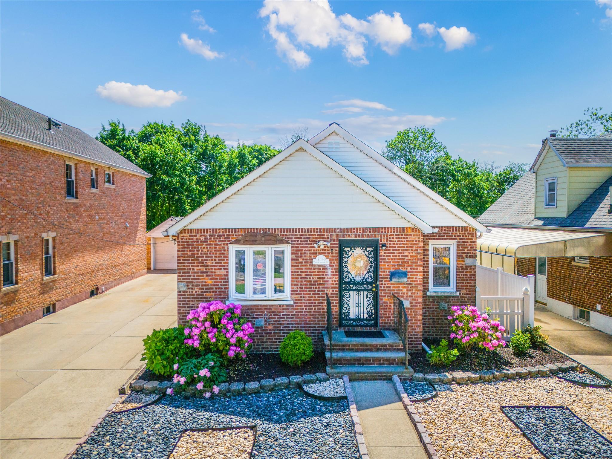 171-40 Pidgeon Meadow Road Queens, NY 11365 - Photo 1 of 1 View of front of home featuring brick siding and a detached garage