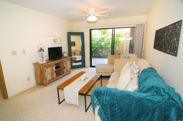 75-123 Lunapule Road, Unit 201 Kailua-Kona, HI 96740 - Photo 2 of 8 a living room with furniture and a flat screen tv