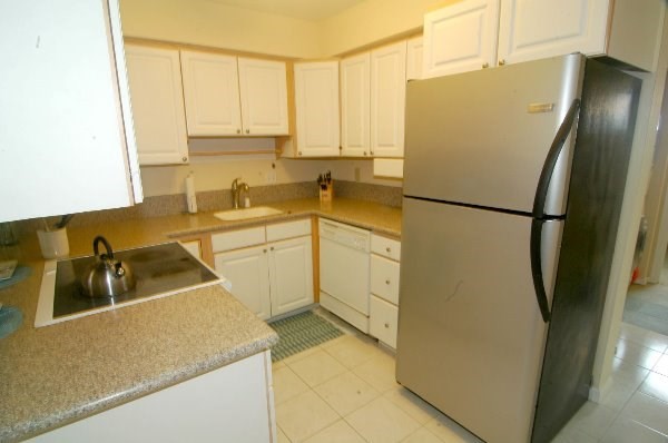 75-123 Lunapule Road, Unit 201 Kailua-Kona, HI 96740 - Photo 3 of 8 a kitchen with a sink a refrigerator and a stove