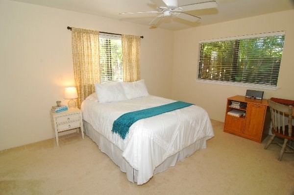 75-123 Lunapule Road, Unit 201 Kailua-Kona, HI 96740 - Photo 4 of 8 a bedroom with a bed chair and a window