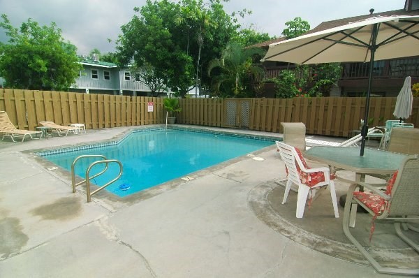 75-123 Lunapule Road, Unit 201 Kailua-Kona, HI 96740 - Photo 8 of 8 a view of a backyard with a patio and wooden fence