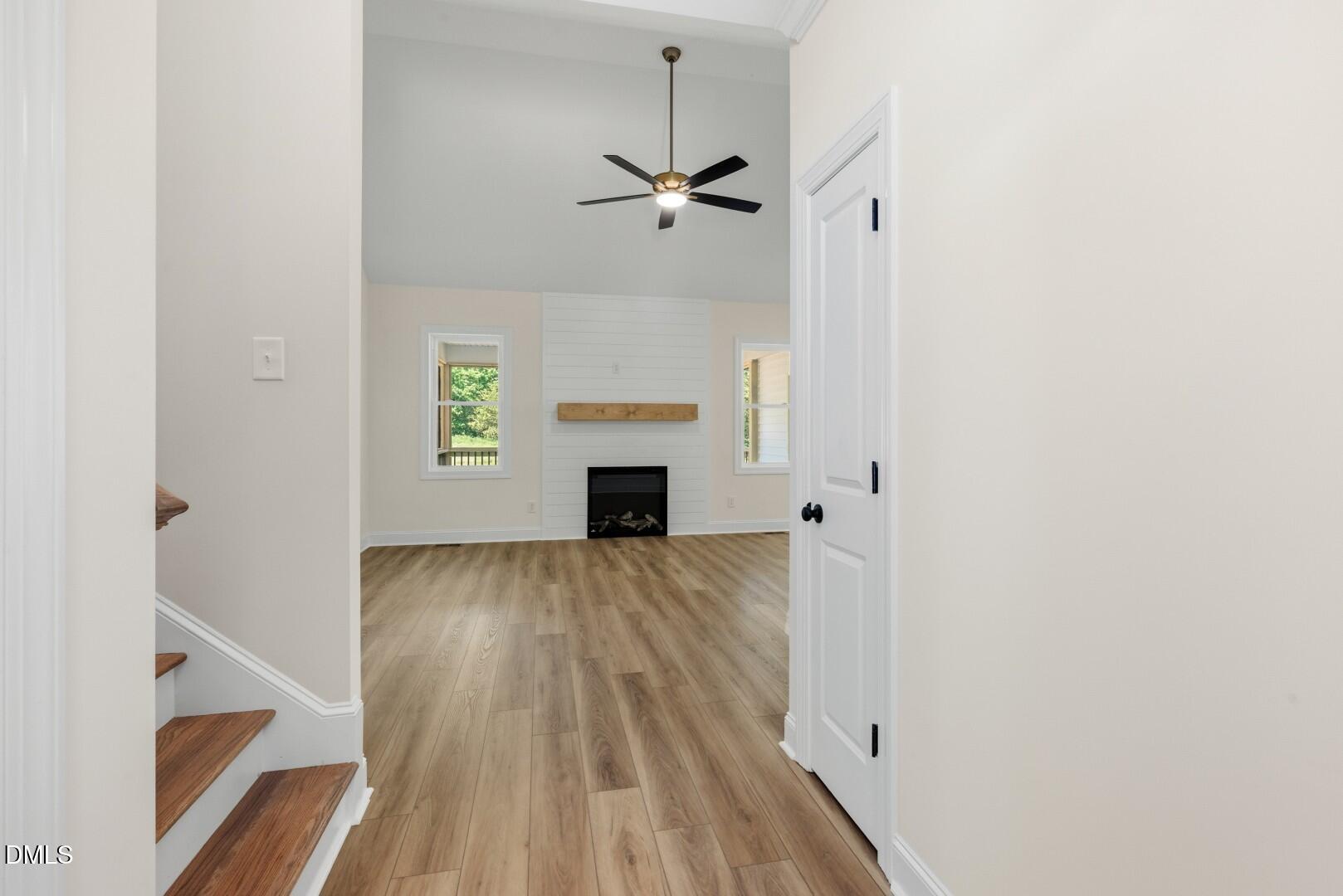 2251 Peachtree Hills Road Spring Hope, NC 27882 - Photo 6 of 46 a view of empty room with wooden floor and fireplace