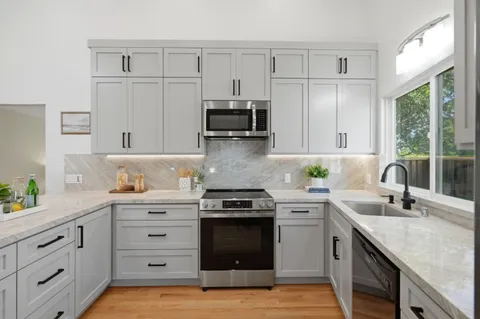 a spacious bedroom with a bed and a chandelier