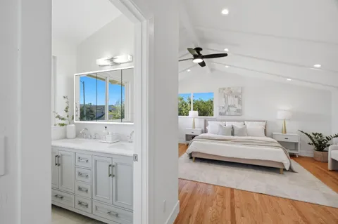 a bedroom with a bed and a dresser with mirror