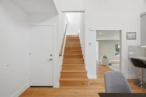 a view of a backyard with table and chairs and wooden fence