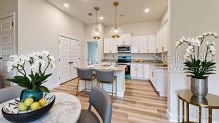1827 Roberts Trail Bell, FL 32619 - Photo 17 of 28 a kitchen with stainless steel appliances kitchen island a table and chairs