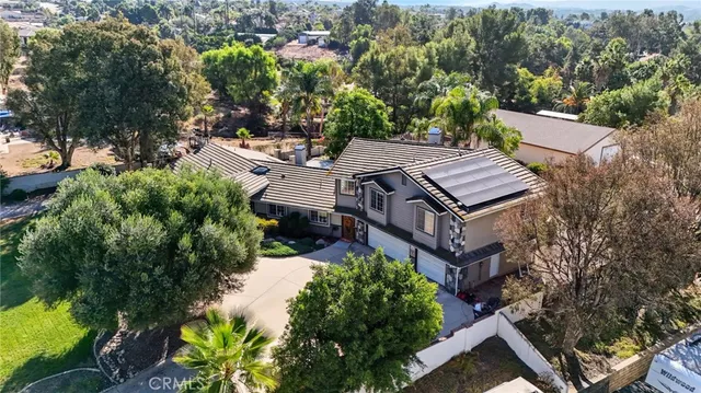 an aerial view of a house with a yard patio and tree s