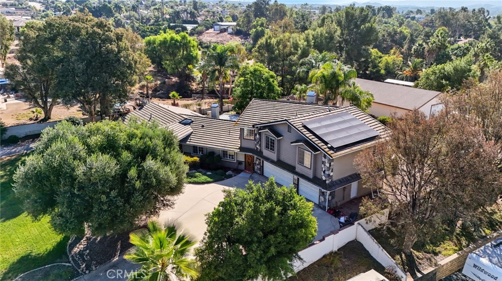 an aerial view of a house with a yard patio and tree s