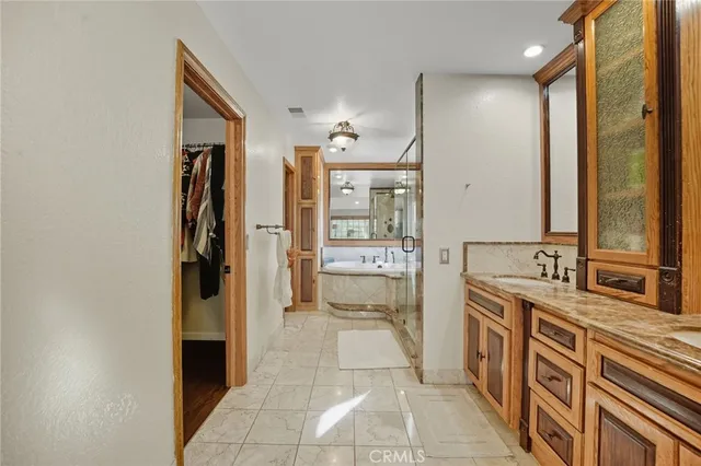a bathroom with a double vanity sink mirror and bathtub