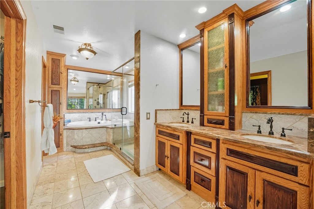 15901 Viewpoint Road Riverside, CA 92504 - Photo 24 of 46 a bathroom with a double vanity sink mirror and bathtub