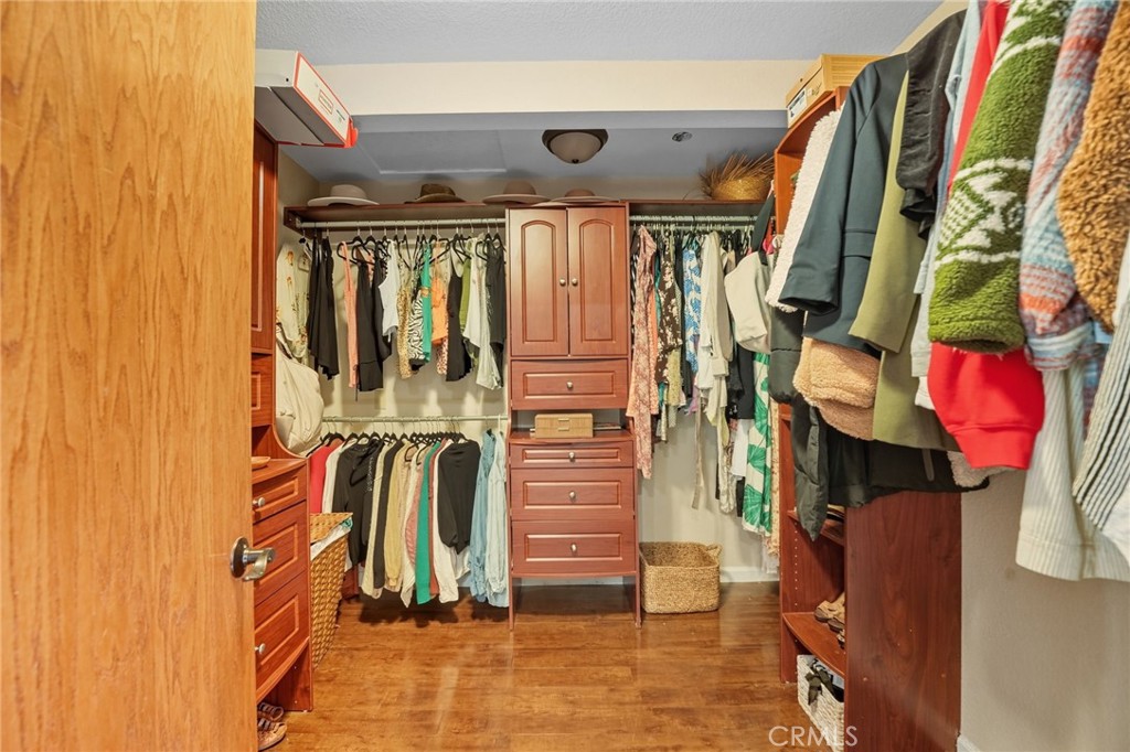 15901 Viewpoint Road Riverside, CA 92504 - Photo 26 of 46 a view of walk in closet with clothes and shoes