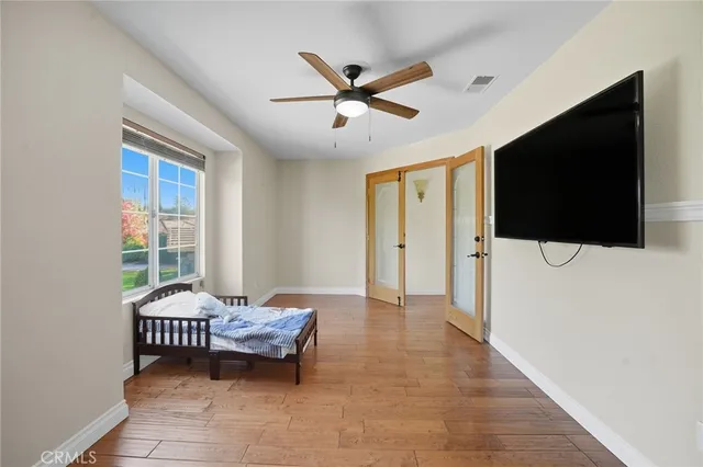 a bedroom with a large bed and a chandelier